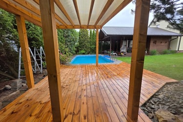 a wooden deck with a pool and a wooden deck