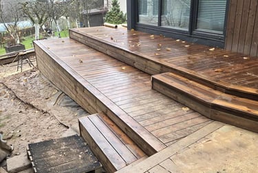 a wooden deck with a bench and a bench
