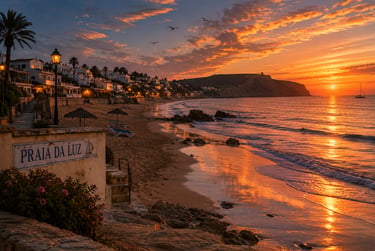 Golden sunset over Praia da Luz beach in Portugal with ocean waves and coastal village lights.