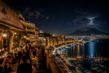 Elegant night dining on a terrace in Naples overlooking Mount Vesuvius and the illuminated coastline.