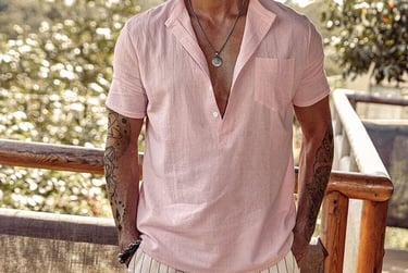 a man in a pink shirt and white shorts