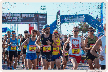 Runners participating in the Crete Half Marathon, moving with determination along the route