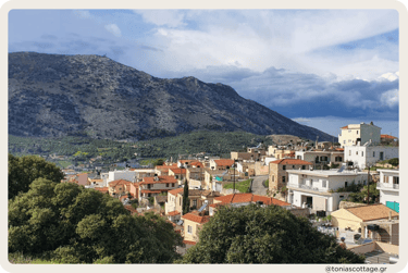 View of Archanes village with green landscapes, traditional old houses, and surrounding mountains