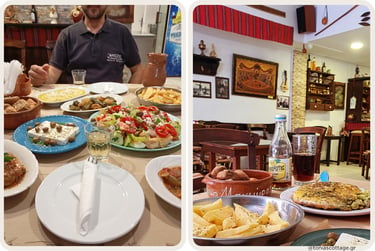 A spread of traditional Cretan dishes on the table at a rustic local taverna in Crete.