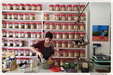 Woman scooping dried herbs in a shop lined with jars on shelves