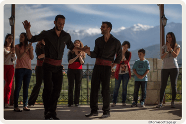 Traditional Cretan dance performance with people watching attentively