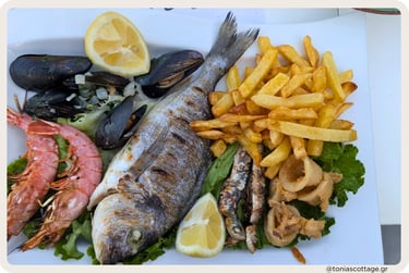 Mixed seafood platter with grilled fish, prawns, mussels, fried calamari and sardines