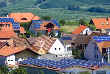 a group of houses with solar panels on the roof in gujarat