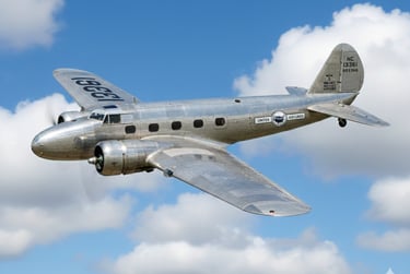 a silver airplane flying through the sky