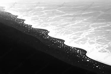 Contemporary black and white minimalist composition of a black sand beach, emphasizing contrast 