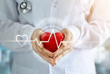 A doctor in a white coat holding a red heart with a digital pulse line for cardiac health care.