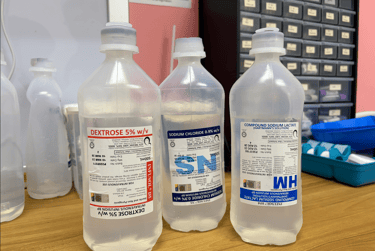 Three medical IV infusion bags containing Dextrose 5%, Sodium Chloride 0.9%, and Compound Sodium Lactate.