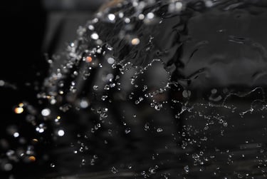 a close up of a water fountain with water droplets