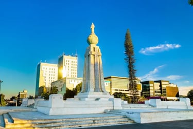 The Monument to the Savior of the World in San Salvador, El Salvador, under a clear blue sky.