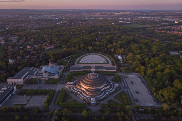 Aerial view of Centennial Hall and the surrounding park in Wroclaw, Poland at sunset.