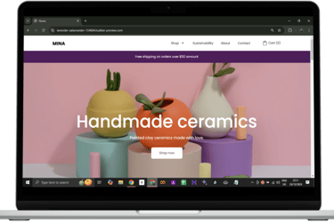 a laptop computer screen displaying a website page with a handmade ceramic vase