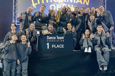 A youth dance team celebrates winning first place at the Lithuanian Open Dance Team Association competition.