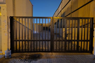 Heavy-duty industrial mild steel swing gate for warehouse entrance in Sharjah.