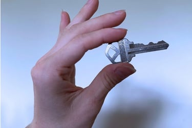 Hand holding a key for duplication service in Asheville