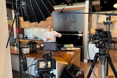 Chef Andrew filming appliance content in a showroom.