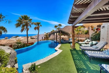 Luxury villa in Pedregal, Cabo San Lucas, with a large pool and palapa overlooking the ocean.