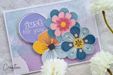 Handmade card with watercolor background, clustered colorful flowers and "Just for you" sentiment.