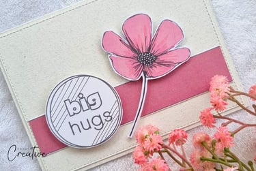 Handmade greeting card with dark pink stripe and big pink flower and "Big hugs" sentiment on it.