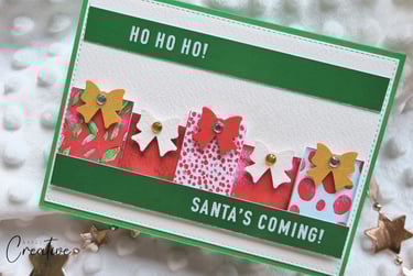 Handmade Christmas card with little gifts and "Santa's Coming" sentiment