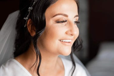 a brunette women having her bridal makeup done