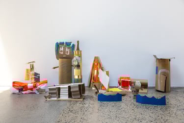 An array of several cardboard sculptures.