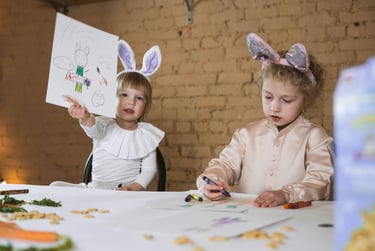 two little girls in bunny ears coloring