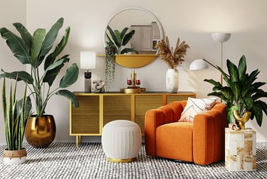 Contemporary boho-style living room with orange armchair, gold and rattan sideboard, round mirror.