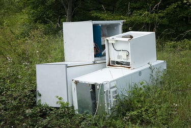 large appliances abandoned in a field