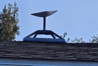 A Starlink satellite internet dish mounted on a residential roof for high-speed connectivity.