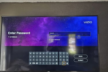 Vizio smart TV screen displaying a password entry keyboard over a purple galaxy background.