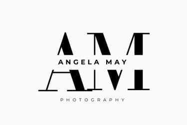 Angela May Photography logo featuring modern black serif initials AM with a creative mirrored reflection.