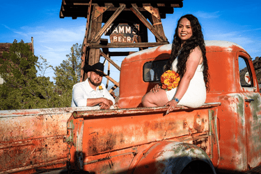 a man and woman sitting in a truck bed
