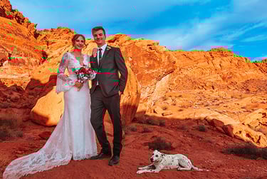 a man and woman standing in front of a mountain