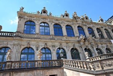Ornate Baroque architecture of the Zwinger palace in Dresden, Germany with sculptures and arched windows.