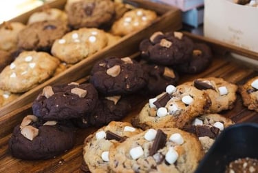 a variety of cookies and cookies on display at a bakery