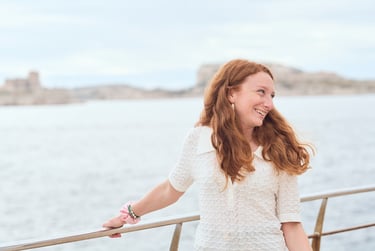 red-haired woman looking back while walking through the streets of endoume, Marseille