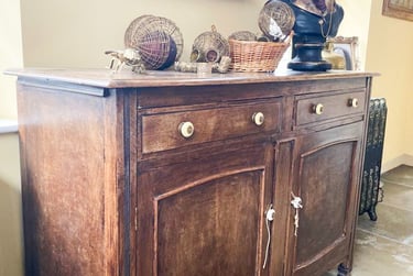 Image of a sideboard that is brown wood and could be painted
