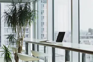 a clean offices with a laptop computer sitting on a table in a room