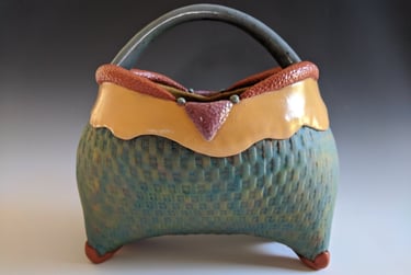 pottery basket by Julie Cunningham in turquoise, amber, and rust