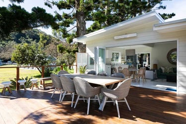 a table with chairs and a table in front of a house