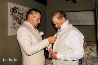 Groom getting ready with groomsman adjusting tie Avalon Castle Melbourne wedding morning