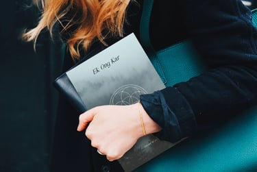 a woman in a black coat and a green purse