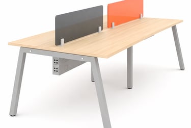 Modern four-person office workstation with light oak tabletop, grey metal legs, and colorful privacy screens.