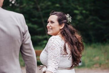 Bride looking at groom while walking.