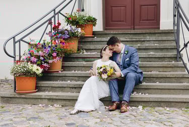 Bride and groom sitting on steps.